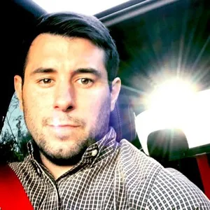 Color-filtered photograph of Dan Hannum from the shoulders up, with a lens flare