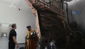 Matt Damon stands staring at a CGI wooden ship, with a Christopher Columbus-like figure in front of it