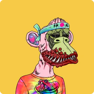 A green zombie-looking ape with a red warty mouth and sharp teeth, with a turquoise hachimaki and a tie-dye shirt