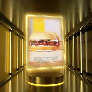 A digital rendering of a gold-chromed card with a picture of a McDonald's McRib on it