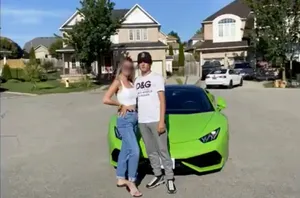 Aidan Pleterski and a woman with her face blurred stand in front of a lime green Lamborghini in what appears to be an upscale suburb