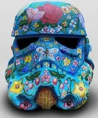 A stormtrooper helmet, painted blue and intricately decorated with flowers and butterflies.